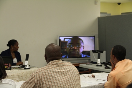 Chief Medical Officer in St. Kitts and Nevis Dr. Patrick Martin speaking to participants at an Integrated Vector Management Workshop sponsored by PAHO via Skype at the Llewelyn Newton Disaster Management Conference Room at lontg point in Nevis. (Up front) Medical Officer of Health on Nevis Dr. Judy Nisbett looks on